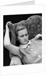1930s woman sitting slumped position with a worried expression and a furrowed brow by Anonymous