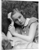 1930s woman moping looking sad or depressed or with a headache leaning her head on her hand looking at camera by Anonymous