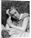 1930s woman moping looking sad or depressed or with a headache leaning her head on her hand looking at camera by Anonymous
