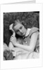 1930s woman moping looking sad or depressed or with a headache leaning her head on her hand looking at camera by Anonymous