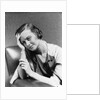 1930s 1940s woman sitting in chair worried sad expression one hand up to her forehead by Anonymous