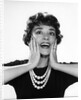 1950s 1960s woman 3 strand necklace hand up to cheeks happy smiling by Anonymous