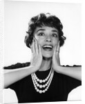 1950s 1960s woman 3 strand necklace hand up to cheeks happy smiling by Anonymous