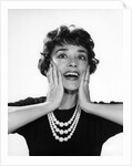 1950s 1960s woman 3 strand necklace hand up to cheeks happy smiling by Anonymous