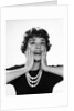 1950s 1960s woman 3 strand necklace hand up to cheeks happy smiling by Anonymous