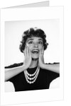 1950s 1960s woman 3 strand necklace hand up to cheeks happy smiling by Anonymous