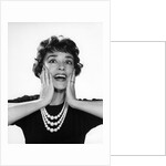 1950s 1960s woman 3 strand necklace hand up to cheeks happy smiling by Anonymous