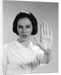 1960s woman looking at camera holding up hand palm forward commanding stop by Anonymous