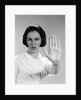 1960s woman looking at camera holding up hand palm forward commanding stop by Anonymous