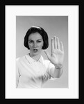 1960s woman looking at camera holding up hand palm forward commanding stop by Anonymous