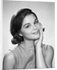 1960s smiling brunette young woman hand to cheek facial expression gesture looking at camera by Anonymous