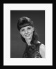 1960s portrait of smiling young woman in sequin dress looking at camera by Anonymous