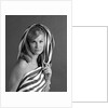 1960s portrait woman wrapped in striped sheet with seductive expression on face looking at camera by Anonymous