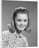 1960s portrait smiling woman wearing print blouse with flip hairdo by Anonymous