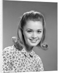 1960s portrait smiling woman wearing print blouse with flip hairdo by Anonymous