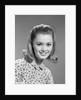1960s portrait smiling woman wearing print blouse with flip hairdo by Anonymous