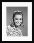 1960s portrait smiling woman wearing print blouse with flip hairdo by Anonymous