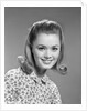1960s portrait smiling woman wearing print blouse with flip hairdo by Anonymous