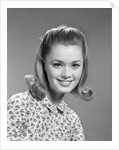 1960s portrait smiling woman wearing print blouse with flip hairdo by Anonymous