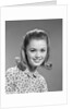 1960s portrait smiling woman wearing print blouse with flip hairdo by Anonymous