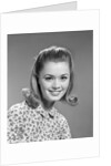 1960s portrait smiling woman wearing print blouse with flip hairdo by Anonymous