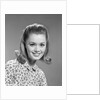 1960s portrait smiling woman wearing print blouse with flip hairdo by Anonymous