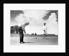 1960s older couple on golfing green man putting by Anonymous
