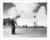 1960s older couple on golfing green man putting by Anonymous