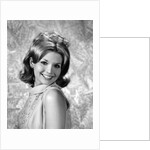 1960s portrait smiling blond woman looking at camera over shoulder by Anonymous