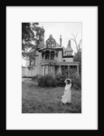 1970s woman in victorian costume standing on front lawn of large abandoned haunted victorian home by Anonymous