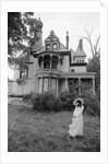 1970s woman in victorian costume standing on front lawn of large abandoned haunted victorian home by Anonymous