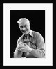 1920s smiling man marking golf club scorecard looking at camera by Anonymous