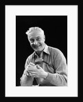 1920s smiling man marking golf club scorecard looking at camera by Anonymous