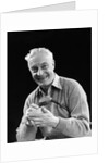 1920s smiling man marking golf club scorecard looking at camera by Anonymous