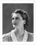 1940s profile portrait brunette woman wearing print dress with lace collar by Anonymous