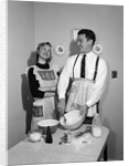 1950s satisfied amused smiling couple husband wife in kitchen cooking together by Anonymous