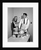 1950s satisfied amused smiling couple husband wife in kitchen cooking together by Anonymous
