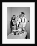 1950s satisfied amused smiling couple husband wife in kitchen cooking together by Anonymous