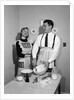 1950s satisfied amused smiling couple husband wife in kitchen cooking together by Anonymous