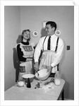 1950s satisfied amused smiling couple husband wife in kitchen cooking together by Anonymous