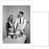 1950s satisfied amused smiling couple husband wife in kitchen cooking together by Anonymous