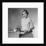 1950s woman looking at camera smiling holding platter of hors d'oeuvres snacks by Anonymous
