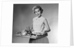 1950s woman looking at camera smiling holding platter of hors d'oeuvres snacks by Anonymous