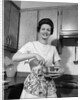 1960s woman kitchen housewife stir by Anonymous