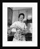 1960s woman kitchen housewife stir by Anonymous