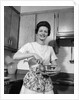 1960s woman kitchen housewife stir by Anonymous