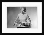1950s woman looking at camera speaking holding platter of hors d'oeuvres snacks by Anonymous