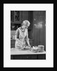 1930s woman in kitchen making strawberry shortcake by Anonymous