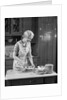 1930s woman in kitchen making strawberry shortcake by Anonymous