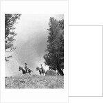 1950s 1960s two men on horseback riding across field wearing cowboy hats by Anonymous